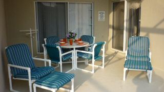 Pool area with table and loungers